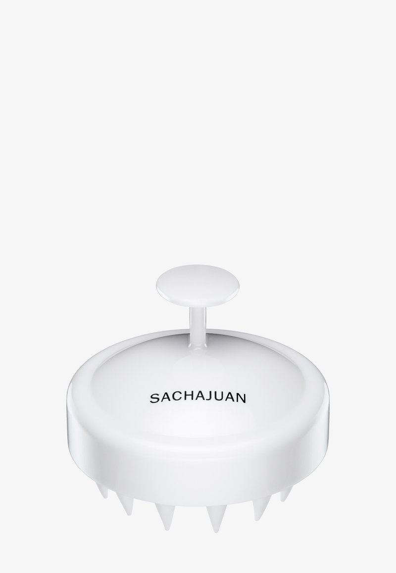 Weißer Kopfhautmassager mit einem glatten, runden Design und einem zentralen Griff. Verfügt über sechs kurze Zinken für sanfte Stimulation. Markenname sichtbar.