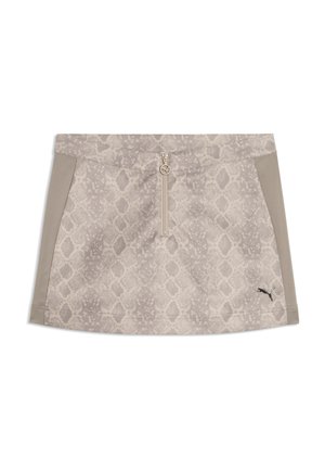 Mini-jupe beige avec motif serpent, panneaux latéraux beige uni, fermeture éclair avant avec tirette circulaire et petit logo Puma noir à l'avant droit.