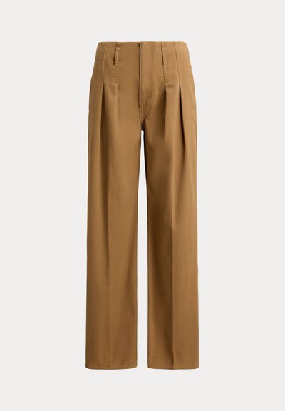 Pantalon marron taille haute, jambes larges, avec plis devant et passants de ceinture, présenté sur un fond uni.