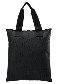 Svart tygväska i strukturerat material med ett geometriskt mönster. Tjocka, robusta handtag och dragkedja upptill.