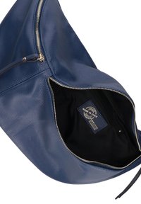 Blauwe leren handtas met een gestructureerd oppervlak, ritssluiting en een zwarte stoffen interieur met een label gemarkeerd "Made in Italy."