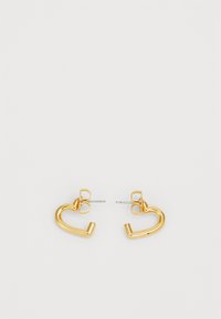 Gold-tone heart-shaped earrings with a polished finish, featuring a post back and a smooth, curved design.