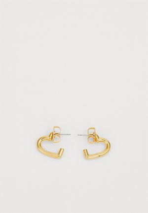 Gold-tone heart-shaped earrings with a polished finish, featuring a post back and a smooth, curved design.
