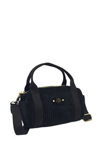 Sac à main en velours côtelé noir avec poignées en tissu, sangle réglable, fermeture éclair et quincaillerie dorée. Présente une texture côtelée verticale.