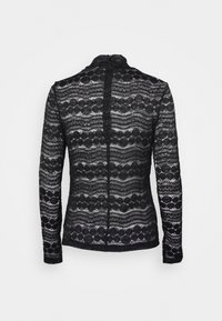 Schwarzes Spitzenoberteil mit langen Ärmeln, das ein gemustertes Design mit kreisförmigen Motiven, einen hohen Kragen und einen verdeckten Reißverschluss auf dem Rücken aufweist.