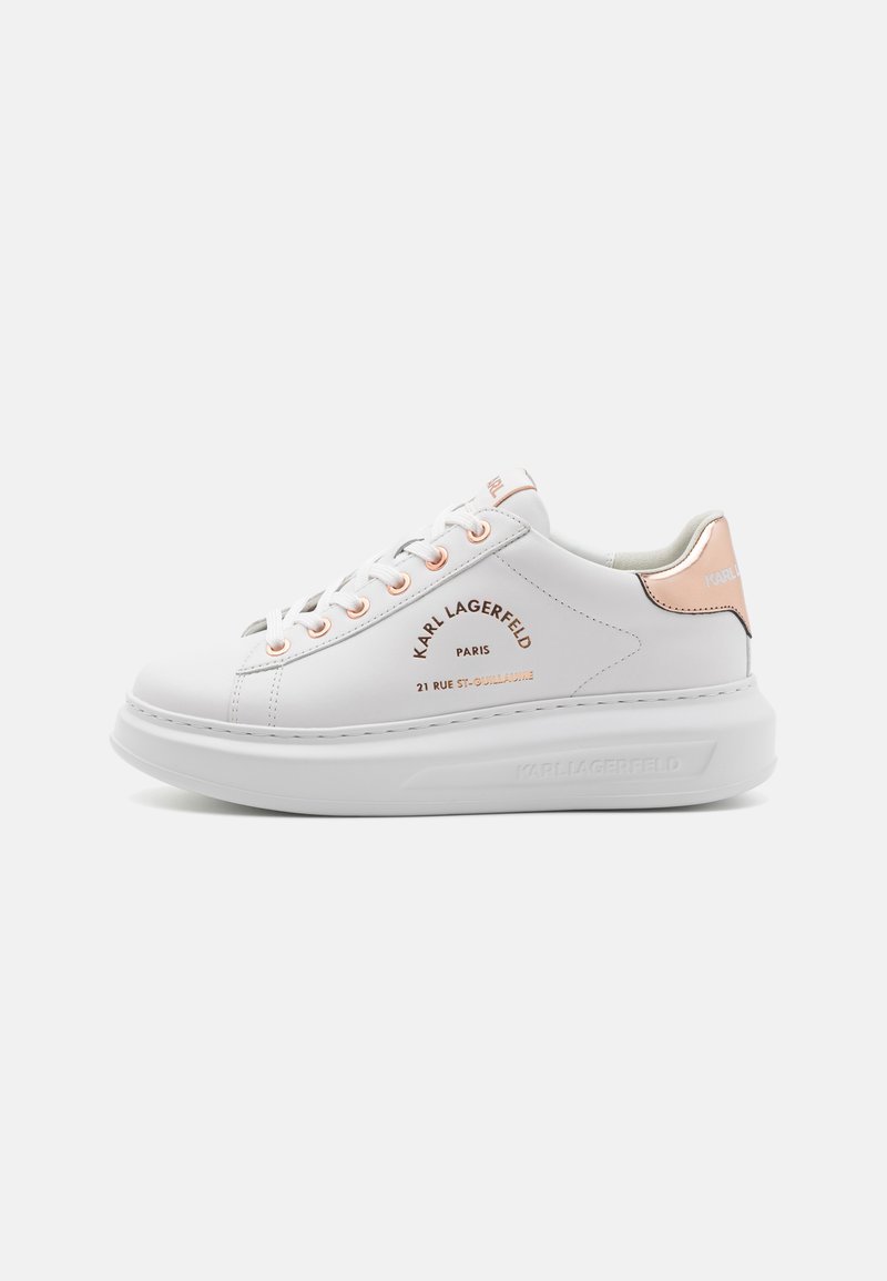 White leather sneaker with padded tongue and collar, rose gold accents, and embossed logo. Thick white sole with subtle stitching detail.