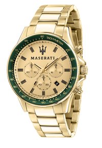 Guld rustfrit stål ur med en grøn bezel, guld urskive og sorte romerske tal. Har en chronograf og vandmodstand op til 100 meter.