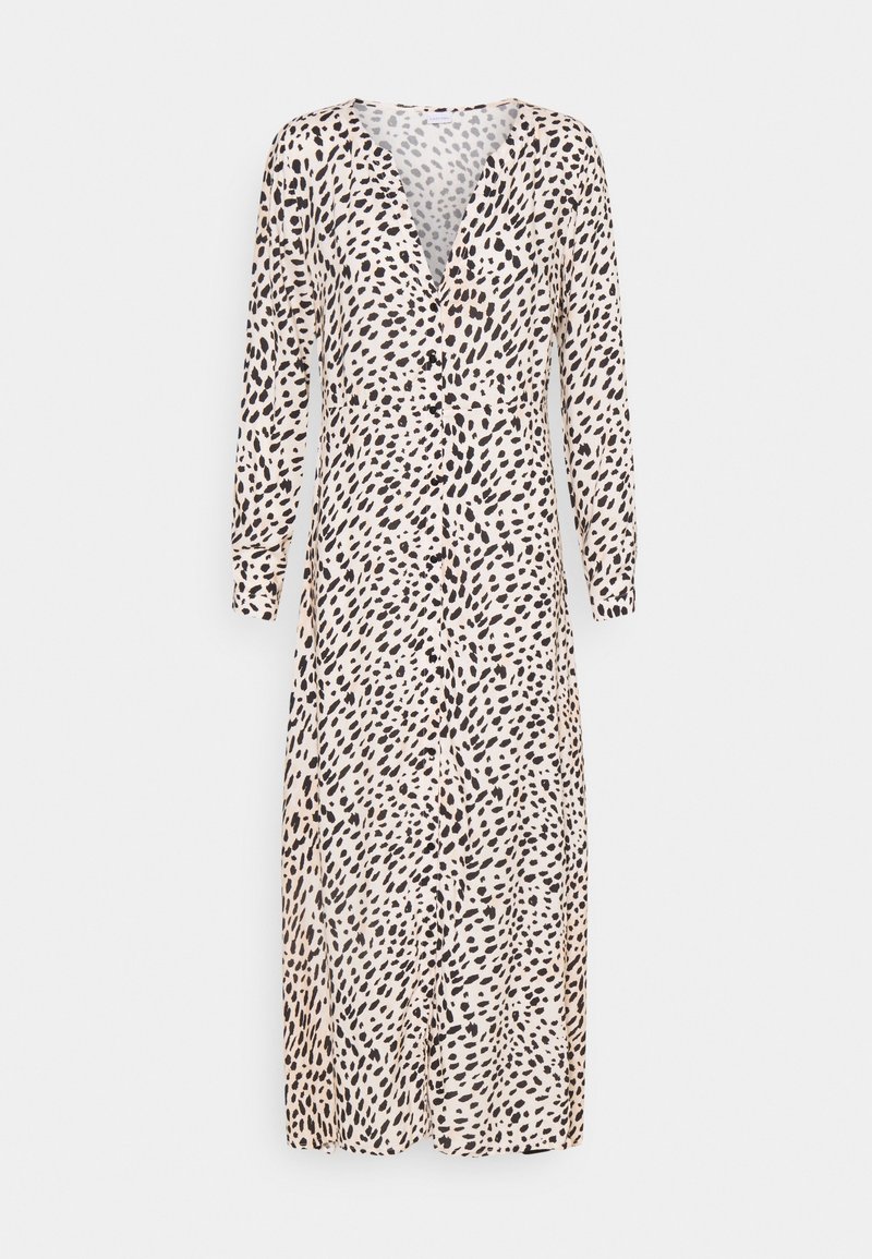 Robe midi à manches longues avec des taches noires irrégulières sur un fond beige et des boutons sur le devant.