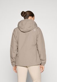 Khaki veekindel jakk kapuutsiga, elastsete mansettide ja diskreetse brändingu ning taga krae peal. Sile tekstuur ja kerge disain.