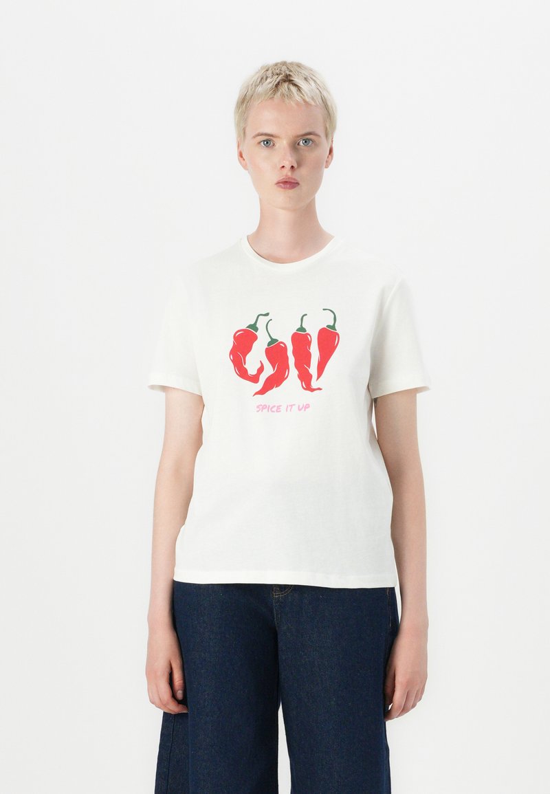 White cotton t-shirt featuring a graphic of red chili peppers and the text "SPICE IT UP" in pink. Short sleeves and a round neckline.