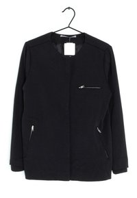 Black jacket with a round neckline, featuring a front zip pocket and two side zip pockets. Made from textured fabric with ribbed cuffs.