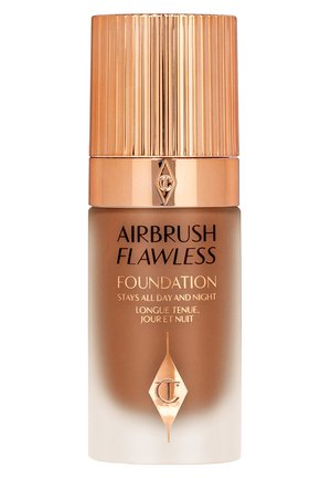 Airbrush Flawless foundation in a sleek glass bottle with a ridged, metallic gold cap and brown gradient finish, featuring embossed logo and text.