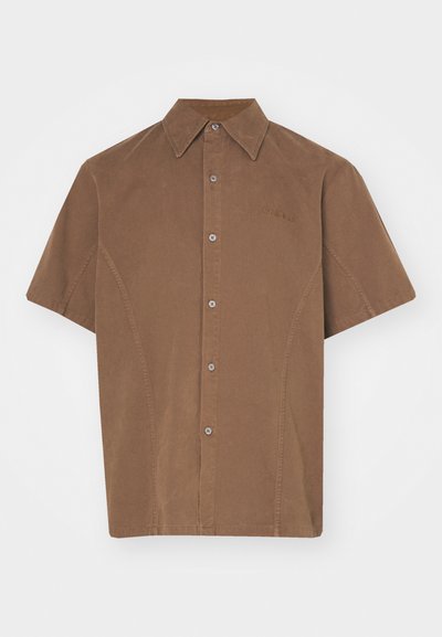 Brown short-sleeve button-up shirt in a soft fabric with a pointed collar and subtle stitching details. Features front buttons and a logo.