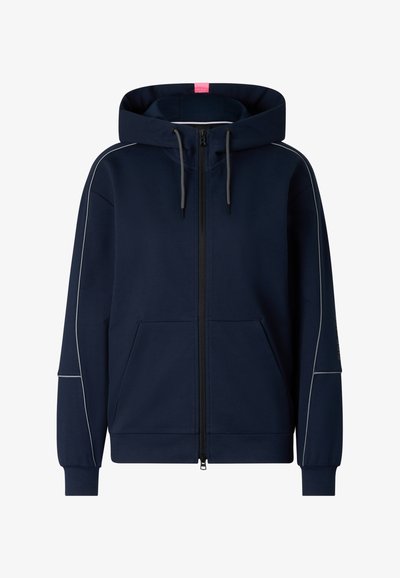 Marineblå lynlås-hættetrøje med forlommer, justerbare sorte snore og tynd hvid piping langs ærmer og skuldre.
