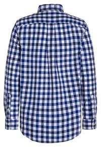 Koszula z długim rękawem zapinana na guziki w granatowo-biało-szary wzór w kratę, widziana od tyłu.