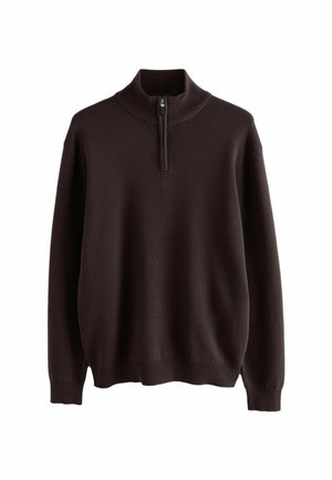 Tumepruun pullover-sweater kõrge ribaga krae ja pool-tioniga. Omab pikkade varrukatega ja pehmet, tekstuurset kudumisest valmistatud kangast.