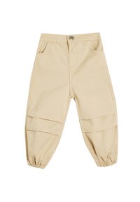 Beige bomuldsbukser med en afslappet pasform, der har elastiske cuffs, to frontlommer og vandrette patchwork-detaljer på benene.