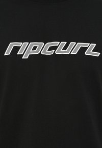 Black t-shirt featuring a bold, white "ripcurl" logo. The fabric appears smooth with a classic crew neckline and a relaxed fit.