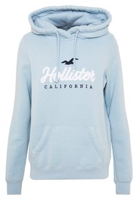 Felpa con cappuccio azzurro chiaro con coulisse, caratterizzata da una tasca frontale e dalla scritta stampata "Hollister California" in bianco e blu navy.