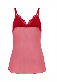 Κόκκινο τοπ με δαντελένιο τελείωμα, ρυθμιζόμενες τιράντες, εφαρμοστή μπλούζα και ημιδιαφανές ύφασμα με μικρά πουά σχέδια.