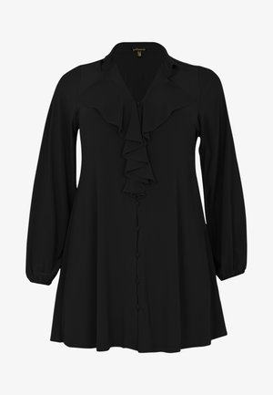 Blouse noire à manches longues et devant volanté. Présente un design à boutons et une texture de tissu douce. Forme légèrement évasée.