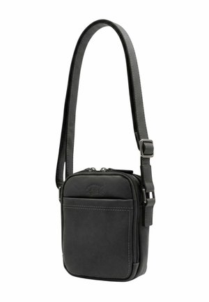 Petit sac bandoulière en cuir noir compact avec sangle réglable, poche avant et fermeture éclair double.
