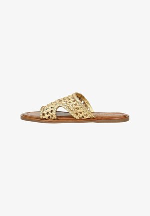 Guldvævet slide sandal med krydsede stropper, flad lædersål og en struktureret overdel, der har et åbent tådesign og minimalistisk stil.