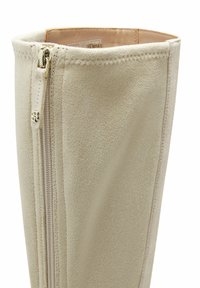 Bota beige de ante hasta la rodilla con textura suave, con cremallera lateral y detalles de costura fina en la parte superior.