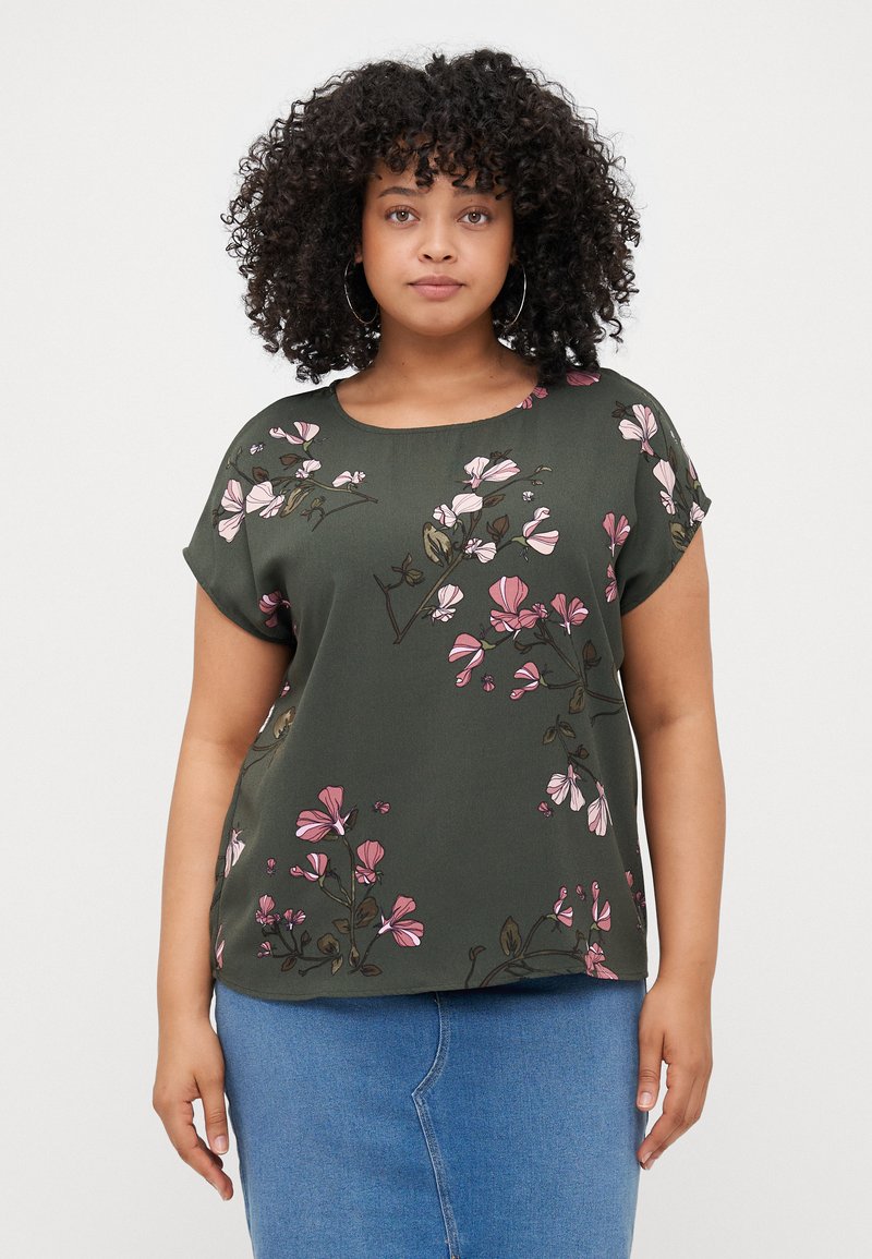 Short-sleeve dark green top featuring pink floral pattern and rounded neckline. Fabric appears smooth with a relaxed fit.