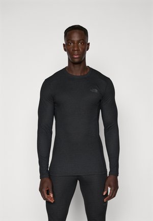 Langarm-Sportshirt in Dunkelgrau, mit einer strukturierten Passform und einem kleinen Logo auf der oberen linken Seite. Glattes Gewebe mit einer subtilen Textur.