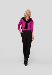 Magenta long-sleeve shirt with black scarf, black tapered trousers, and black ankle boots. Smooth fabric and fitted design.