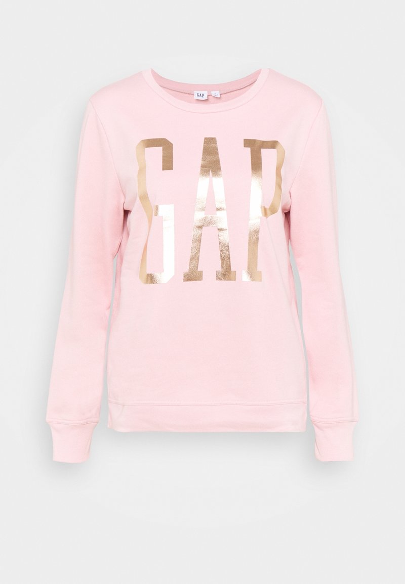 Ljusrosa långärmad sweatshirt med stor skinande guldig "GAP"-logotyp över framsidan, rundad hals och ribbade ärmslut och fåll.