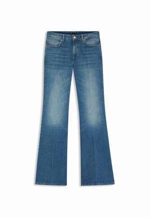 Jean en denim bleu évasé avec un lavage délavé, doté de cinq poches, braguette à boutons, et ourlets bruts aux extrémités évasées.