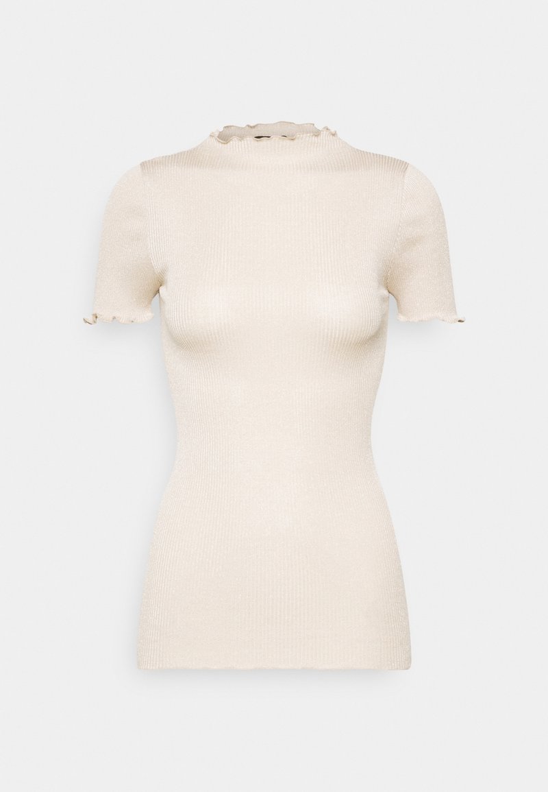 Cream-colored short sleeve ribbed knit top with mock neck and ruffled edges on sleeves and collar.
