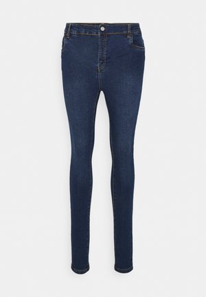 Jeans skinny azul escuro feitos de denim, com um clássico design de cinco bolsos, fecho de botão e detalhe de costura em contraste.