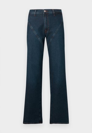 Blugi evazați de culoare albastru închis, confecționați din denim, cu talie înaltă, cusături contrastante și un design unic al buzunarului frontal înclinat.