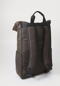 Dark brown rectangular backpack with padded shoulder straps, top handle, side pockets, and a small "Barbour" label near the top.