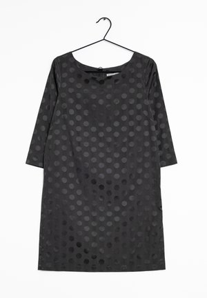 Black long-sleeve knee-length dress with a round neckline and a dark polka dot pattern, hanging on a black wire hanger against white background.