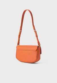 Orange textured leather crossbody bag with adjustable strap and gold-tone hardware on a white background.