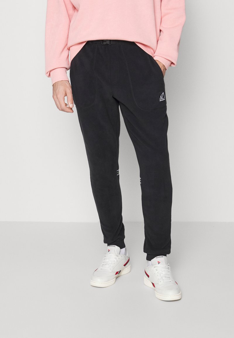 New Balance ALL TERRAIN PANT Tracksuit bottoms black Zalando.de