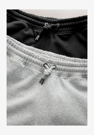 Grå og sorte sweatpants med elastisk talje og snøre. Blød tekstur med en tykk, ribbet finish ved taljesømmen.