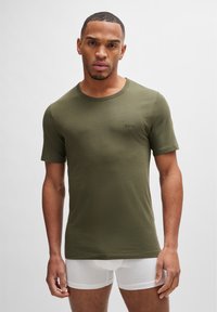 T-shirt fitted color verde oliva con maniche corte; tessuto di cotone morbido; piccolo logo 'BOSS' davanti, scollo rotondo e design semplice.