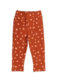 Orange leggings with a stretchy waistband, featuring a pattern of pink dots throughout, smooth texture, and faux pocket details.