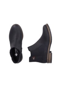 Bottines noires avec un extérieur en cuir texturé, des panneaux latéraux élastiques et des talons en bloc de bois. La semelle est striée pour une meilleure adhérence.