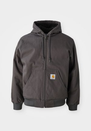 Gray cotton zip-up hoodie with a large front pocket, ribbed cuffs, and hem. Features drawstrings on the hood and brand logo patch.