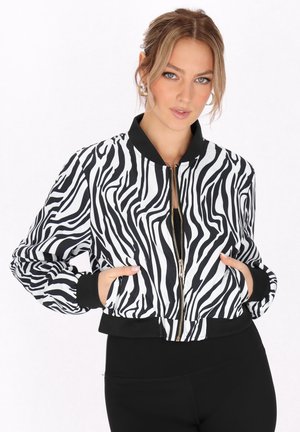 Zebra-mønstret bomberjakke med sorte manchetter og kant, med en frontlynlås og sidelommer. Fremstillet af et glat, let materiale.