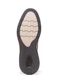 Suola della scarpa con un pattern esagonale, caratterizzata da un centro beige e un bordo esterno in gomma scura, progettata per trazione e durata.