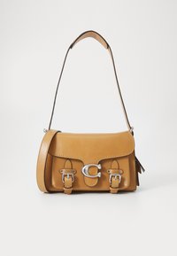 Tan leather handbag with a flap, silver hardware, two buckle accents, and a shoulder strap. Smooth texture with a structured shape.