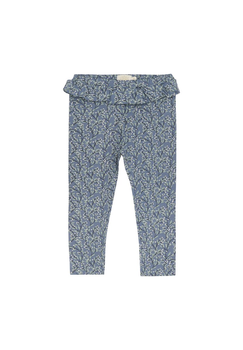 Leggings bleus à motifs avec une ceinture à volants, présentant un design floral en blanc et vert sur un tissu texturé.