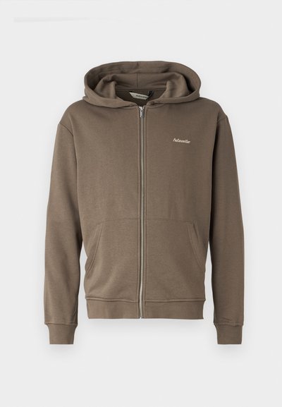 Brown zip-up hoodie made of soft fabric, featuring a drawstring hood, front pockets, and a small embroidered logo on the chest.